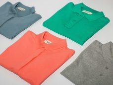 Pressed & Fresh | Folded polo shirts in grey, green, coral, and light grey arranged neatly.